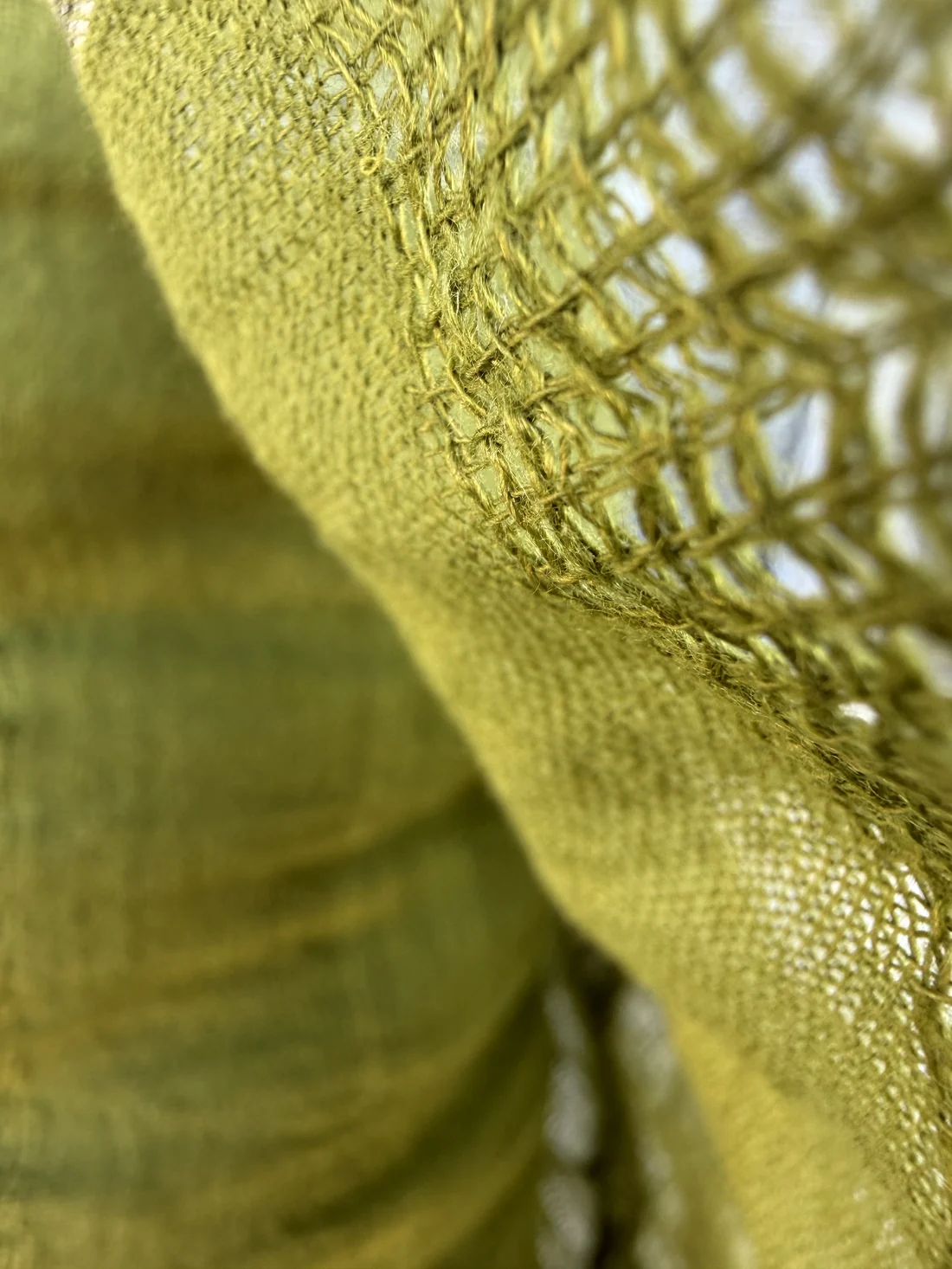 Italian stock fabric close-up — green woven texture, full pieces ready to ship from Prato